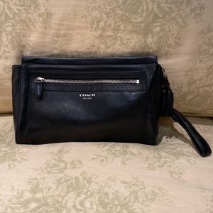 Black leather Coach clutch with silver accents.